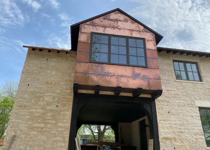 Copper metal panel facade on a stone building for Roof Repair in Lake Charles